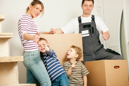 Removal van and movers handling furniture during a Upton home move